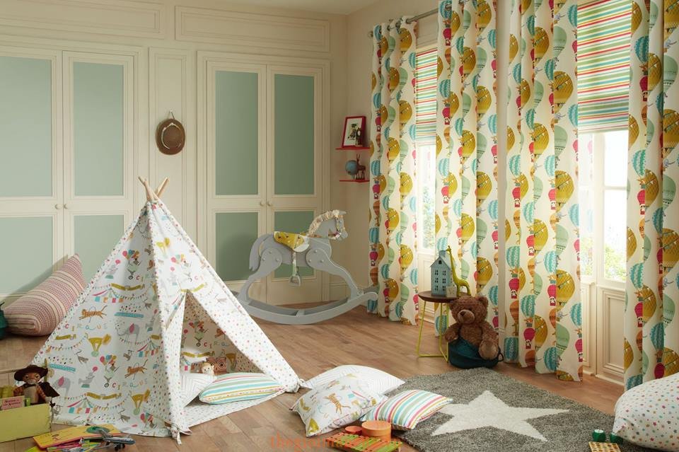 Playful nursery with patterned drapes