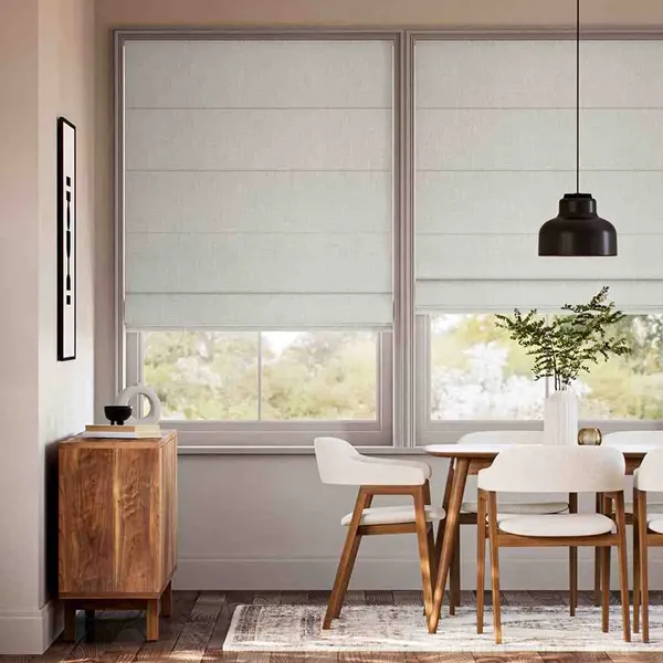 Natural linen Roman blind in a minimalist dining room