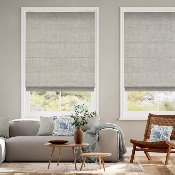 Textured beige Roman blinds in a neutral living room